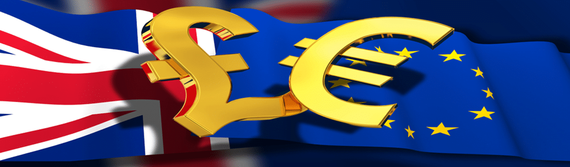The flags of Great Britain and the European Union side by side. In front of the flags are the Pound sign and Euro sign in gold.